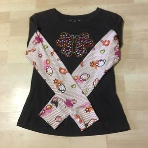 A cute brown shirt with a butterfly on it.